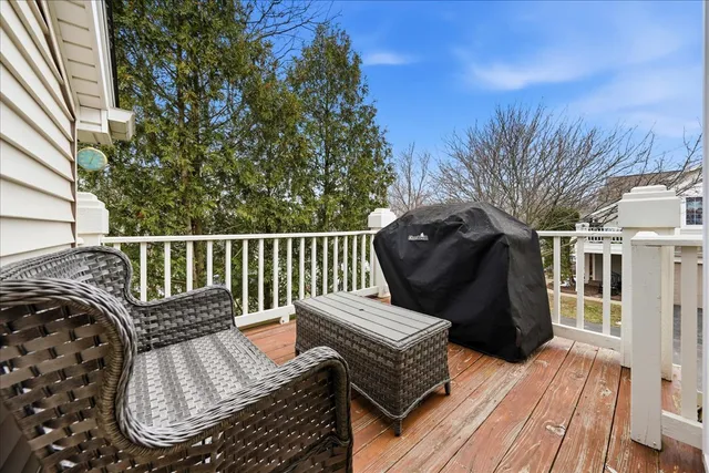 a view of a wooden chairs and bench in the balcony