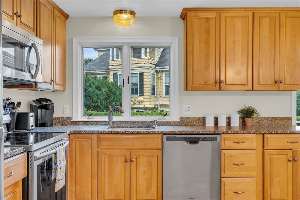 75 Nonantum Street Newton, MA 02458 - Photo 14 of 41 a kitchen with granite countertop stainless steel appliances a sink window and cabinets