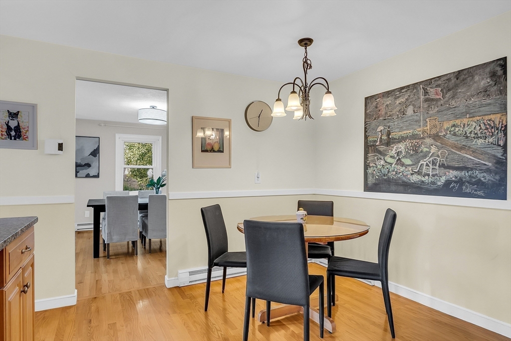 75 Nonantum Street Newton, MA 02458 - Photo 15 of 41 a dining room with wooden floor a chandelier a wooden table and chairs