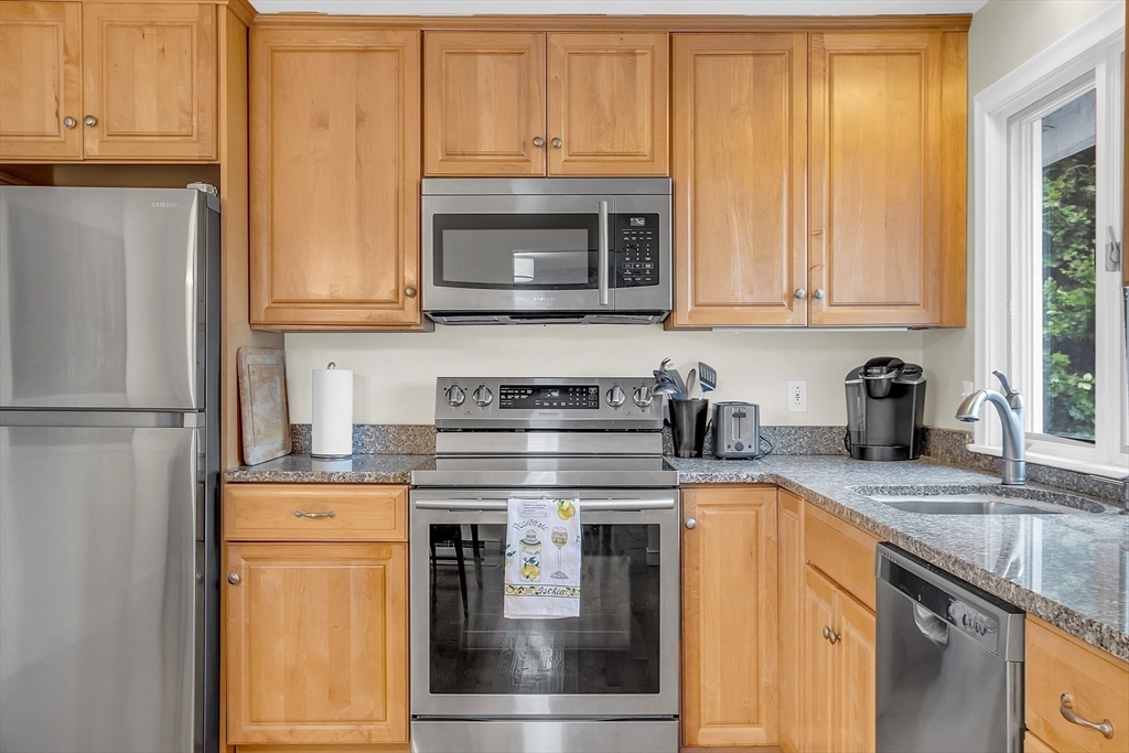 75 Nonantum Street Newton, MA 02458 - Photo 16 of 41 a kitchen with granite countertop a stove top oven cabinetry