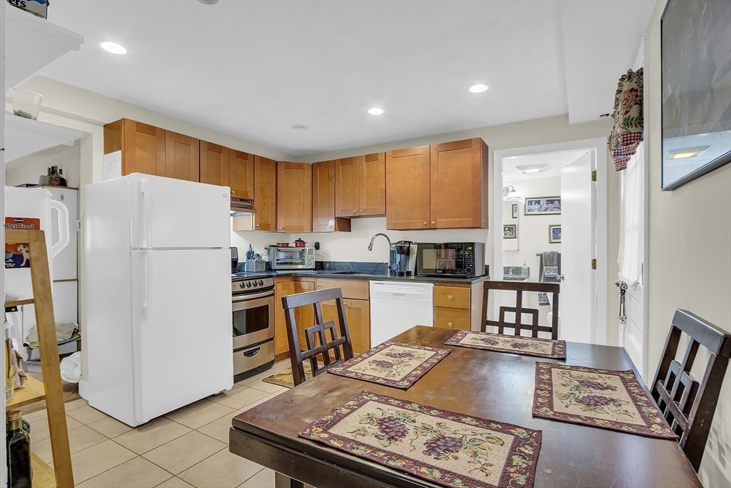 75 Nonantum Street Newton, MA 02458 - Photo 27 of 41 a kitchen with a refrigerator a stove top oven a sink and cabinets