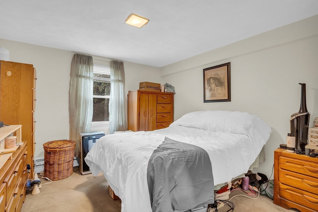 75 Nonantum Street Newton, MA 02458 - Photo 30 of 41 a bedroom with a bed and wooden floor