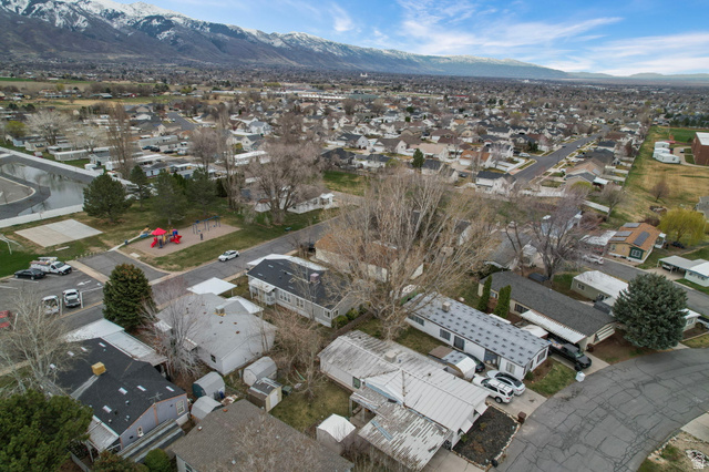 2600 North Hill Field Road, Unit 134 Layton, UT 84041 - Photo 38 of 41 Aerial view of property's location with nearby suburban area and a mountain backdrop