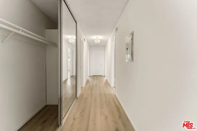 a view of a hallway with wooden floor
