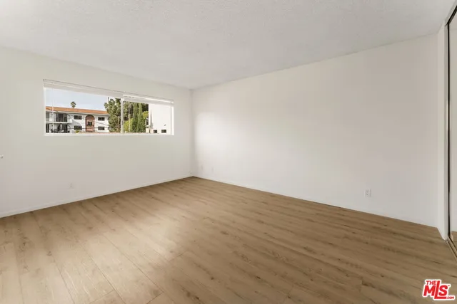 a view of an empty room and wooden floor