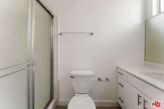 a bathroom with a toilet a sink and a mirror