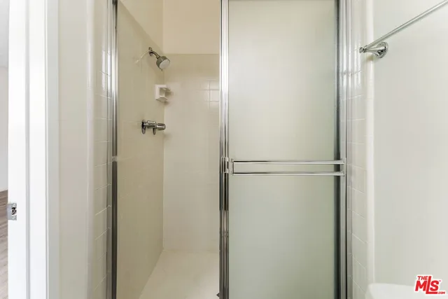 a bathroom with a glass shower door