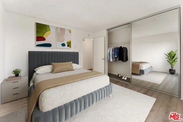 a bedroom with a bed and a television