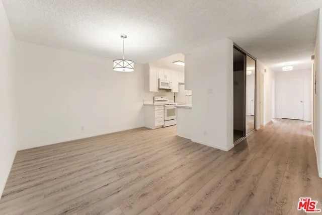 a view of a kitchen with a sink and a wooden floor