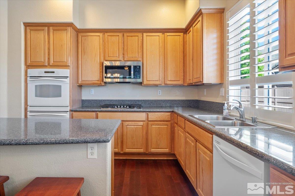 10665 Autumn Walk Lane Reno, NV 89521 - Photo 13 of 35 a kitchen with stainless steel appliances granite countertop a sink a stove and cabinets