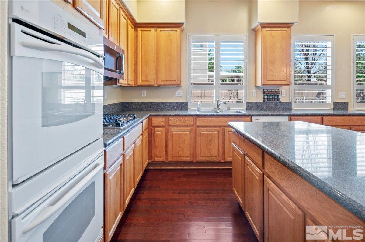 10665 Autumn Walk Lane Reno, NV 89521 - Photo 14 of 35 a kitchen with stainless steel appliances a sink and cabinets