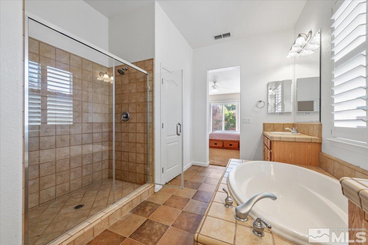 10665 Autumn Walk Lane Reno, NV 89521 - Photo 18 of 35 a bathroom with a tub and shower