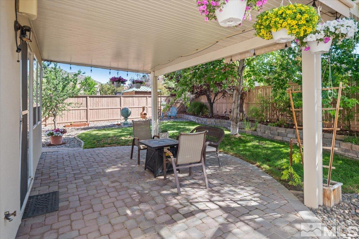 10665 Autumn Walk Lane Reno, NV 89521 - Photo 25 of 35 a view of a patio with a table chairs and a backyard