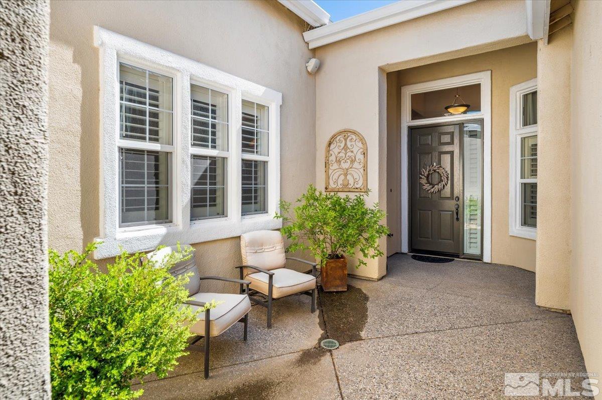 10665 Autumn Walk Lane Reno, NV 89521 - Photo 3 of 35 a view of a entryway door of the house with outdoor seating