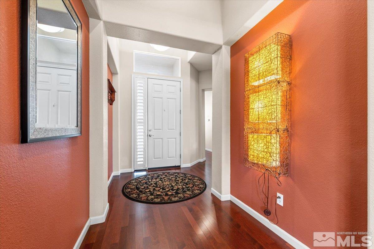 10665 Autumn Walk Lane Reno, NV 89521 - Photo 4 of 35 a view of wooden floor and a chair in a room