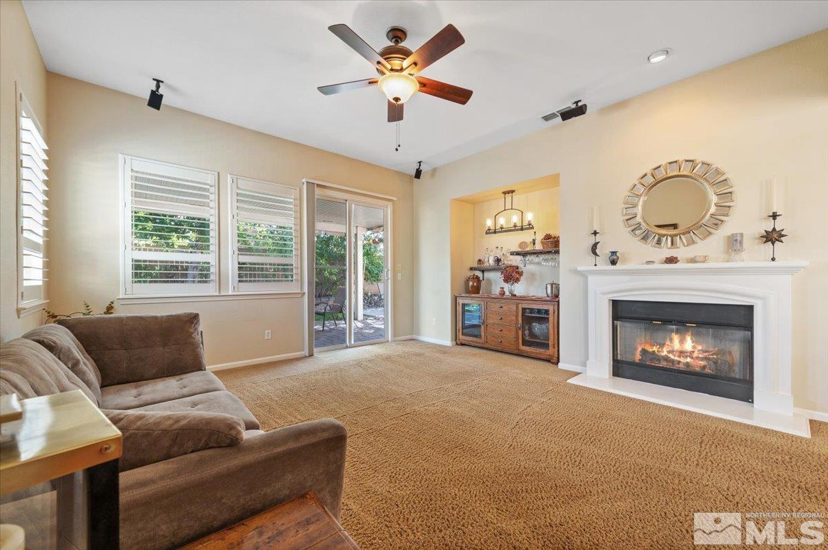 10665 Autumn Walk Lane Reno, NV 89521 - Photo 9 of 35 a living room with furniture and a fireplace
