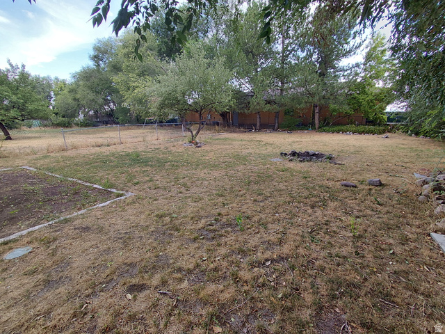 403 Morgan Street Layton, UT 84041 - Photo 7 of 13 Expansive outdoor area featuring mature trees and a fire pit