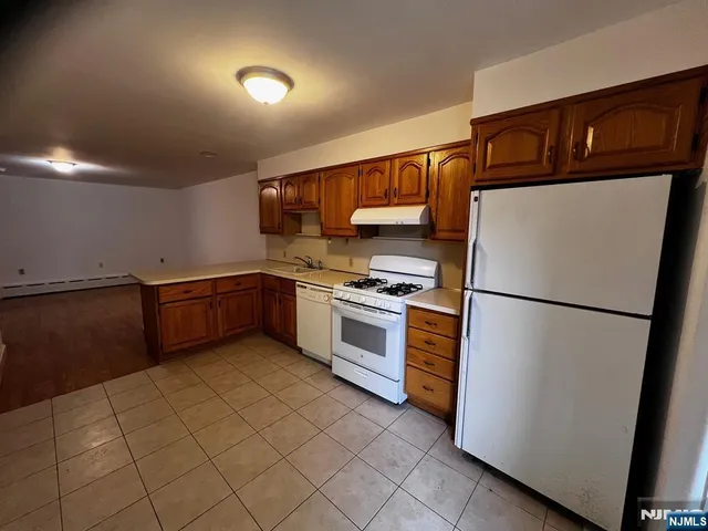 a kitchen with stainless steel appliances a refrigerator sink and cabinets
