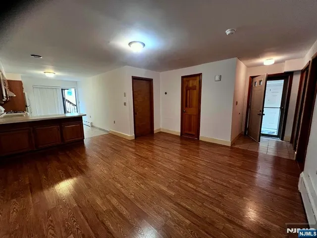 a view of a kitchen with wooden floor and a sink