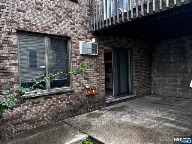 a brick building with a window and a door