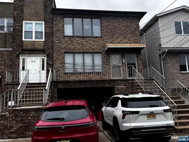 a front view of a house with parking space