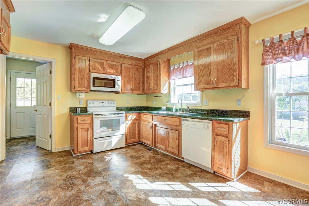 16601 Jolly Road Disputanta, VA 23842 - Photo 22 of 41 a kitchen with granite countertop a stove top oven sink and cabinets