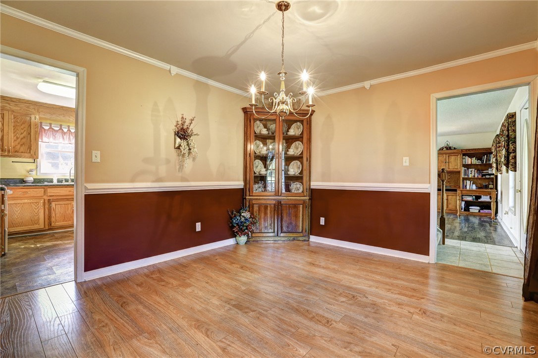 16601 Jolly Road Disputanta, VA 23842 - Photo 26 of 41 a view of a room with wooden floor and chandelier