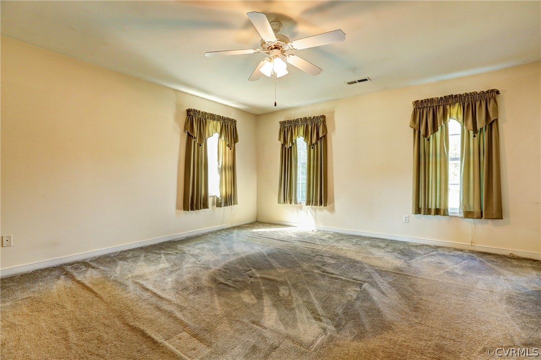 16601 Jolly Road Disputanta, VA 23842 - Photo 29 of 41 a view of an empty room with window and chandelier fan
