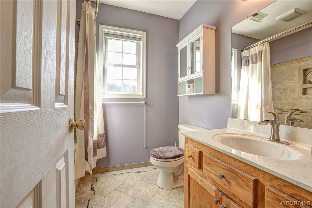 16601 Jolly Road Disputanta, VA 23842 - Photo 34 of 41 a bathroom with a granite countertop sink toilet and shower