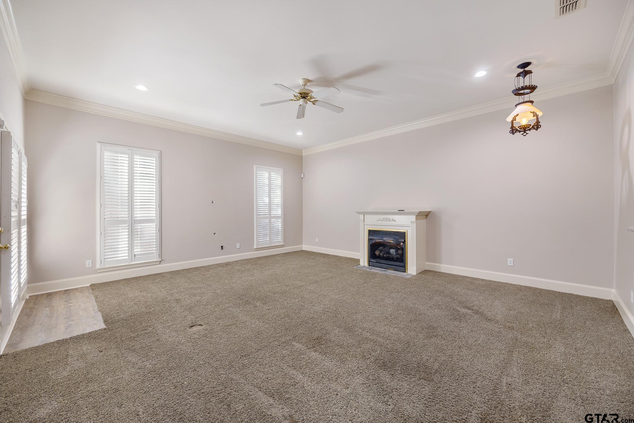 2431 Homestead Lane Tyler, TX 75701 - Photo 13 of 26 an empty room with windows and fireplace