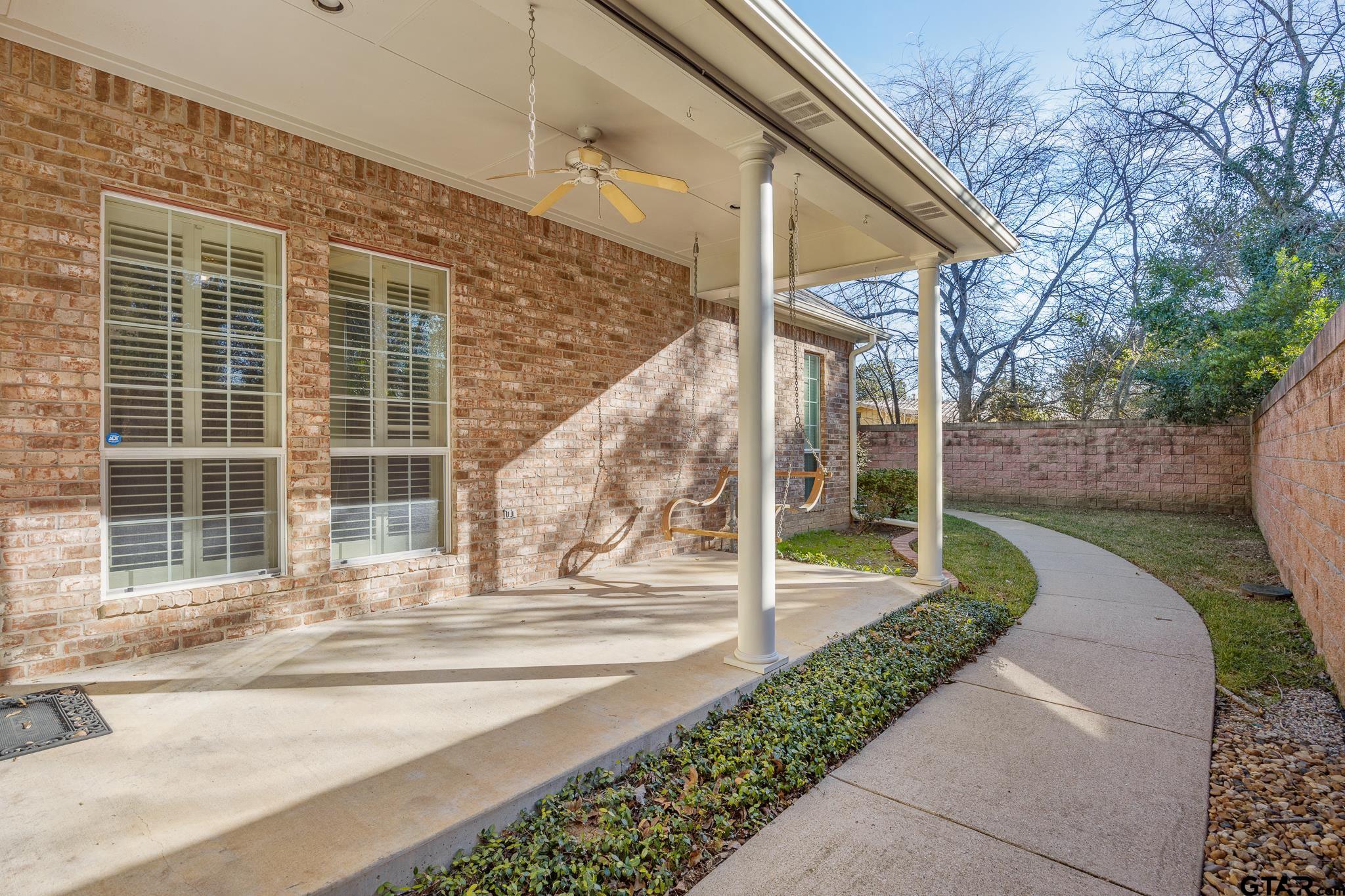 2431 Homestead Lane Tyler, TX 75701 - Photo 23 of 26 a view of a pathway of a house with a porch