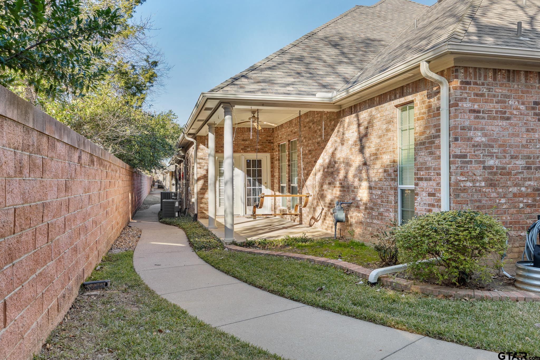 2431 Homestead Lane Tyler, TX 75701 - Photo 24 of 26 a front view of a house with a yard