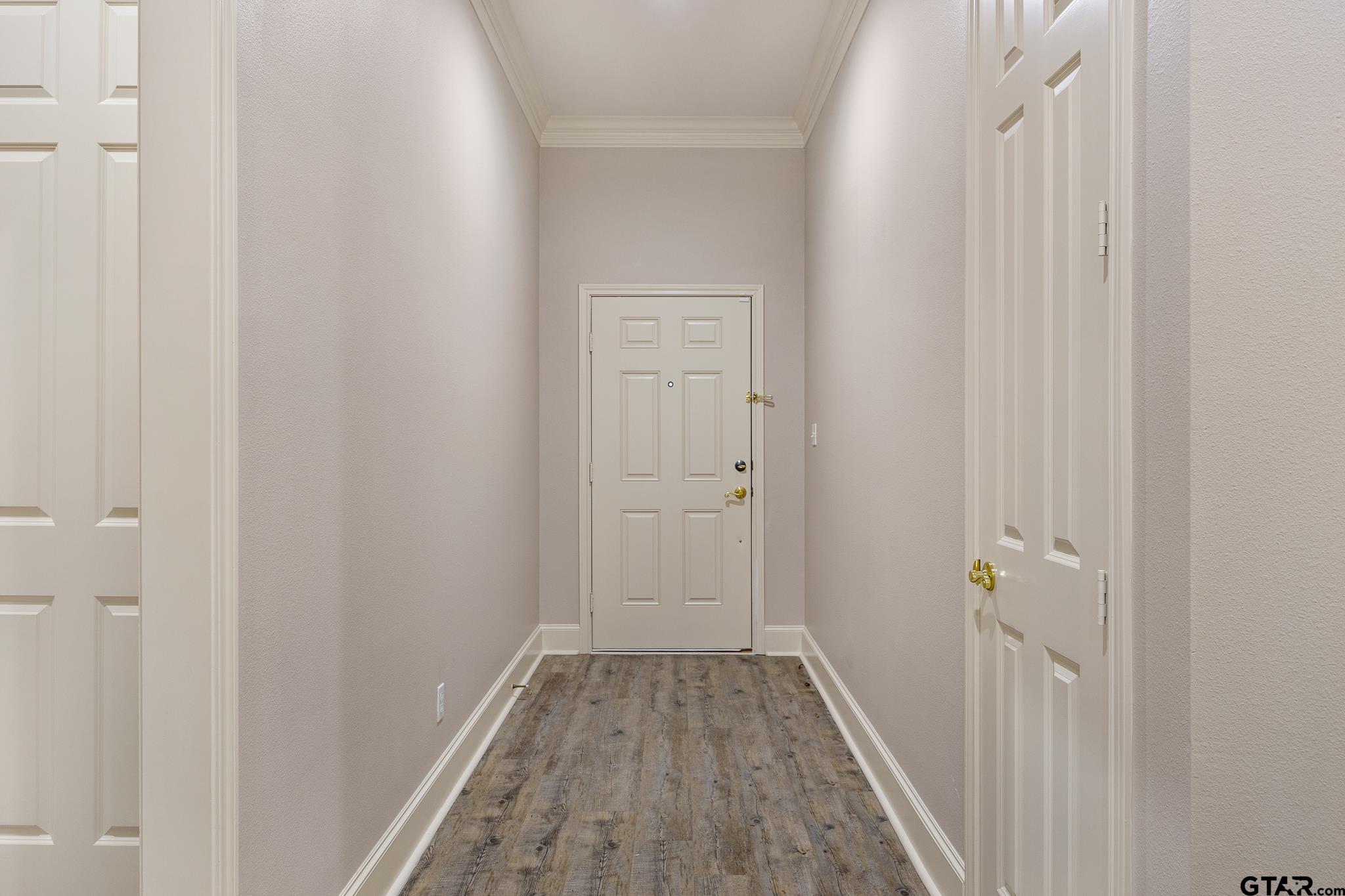2431 Homestead Lane Tyler, TX 75701 - Photo 4 of 26 a view of a hallway with wooden floor and closet