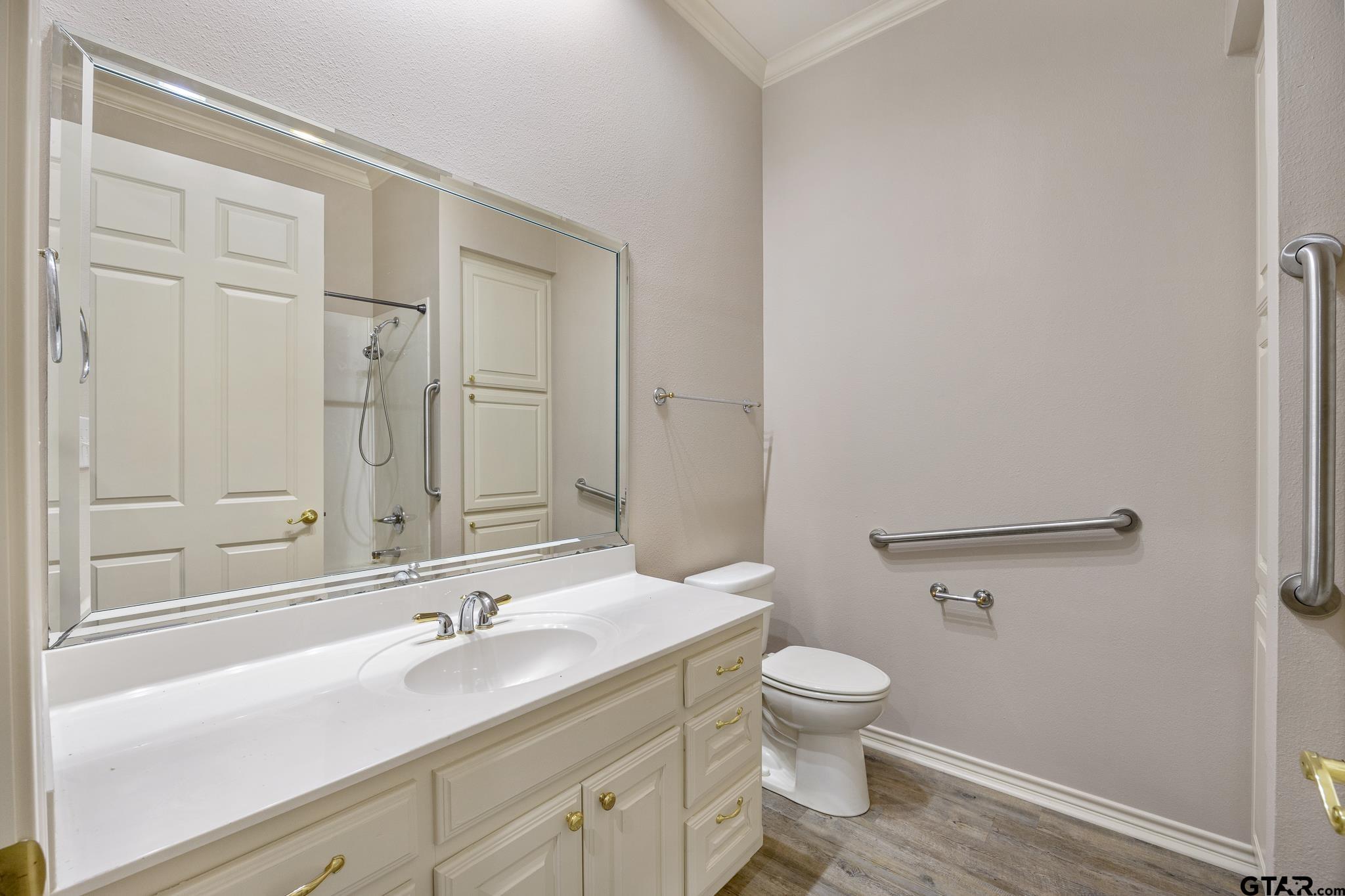 2431 Homestead Lane Tyler, TX 75701 - Photo 8 of 26 a bathroom with a granite countertop sink a toilet and a mirror