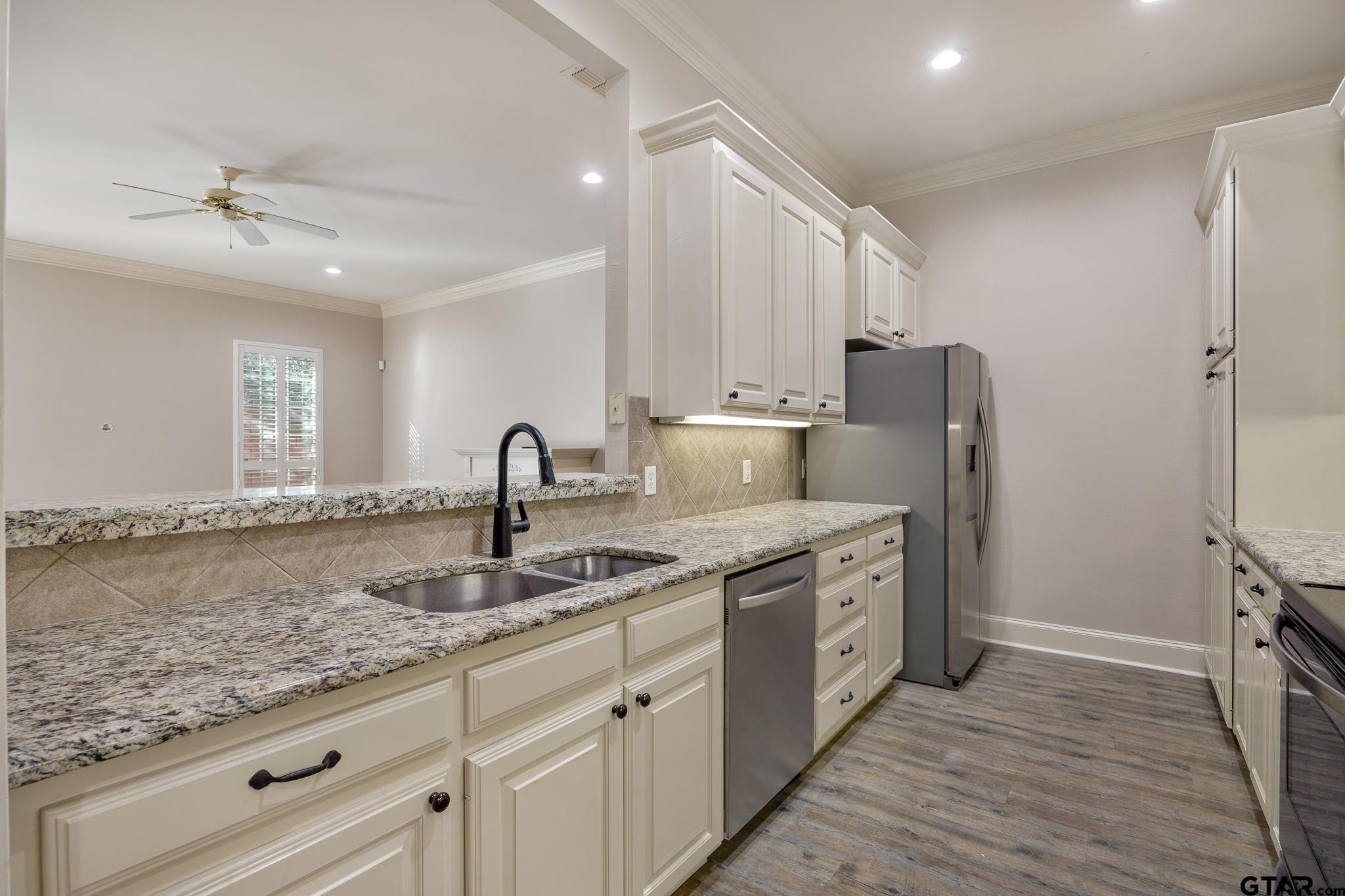 2431 Homestead Lane Tyler, TX 75701 - Photo 10 of 26 a kitchen with a sink cabinets and stainless steel appliances