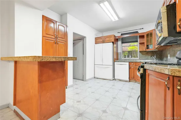 a kitchen with stainless steel appliances granite countertop a refrigerator and a stove