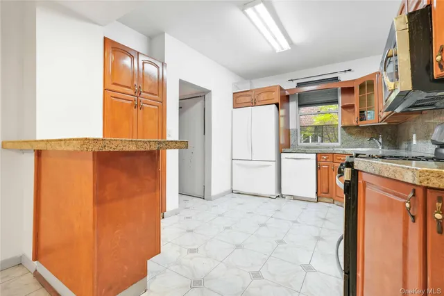 a kitchen with stainless steel appliances granite countertop a refrigerator and a stove