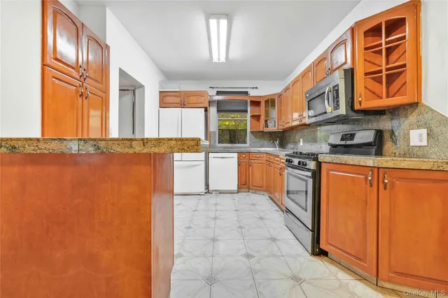 a kitchen with stainless steel appliances granite countertop a stove a sink and dishwasher