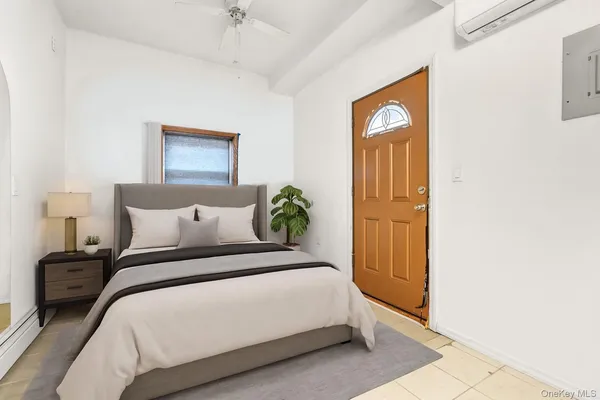 a spacious bedroom with a bed and a potted plant