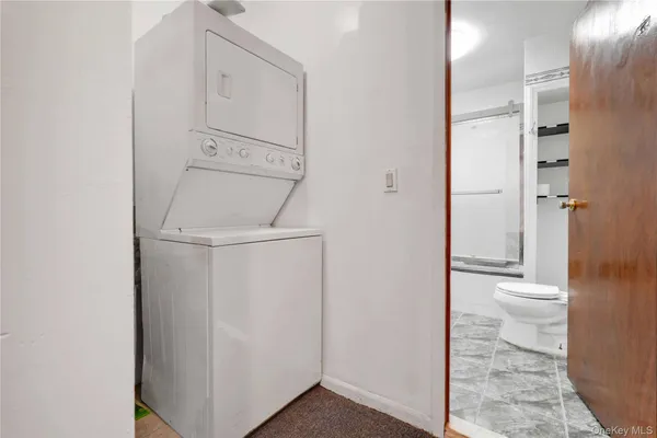 a bathroom with a granite countertop toilet and a sink