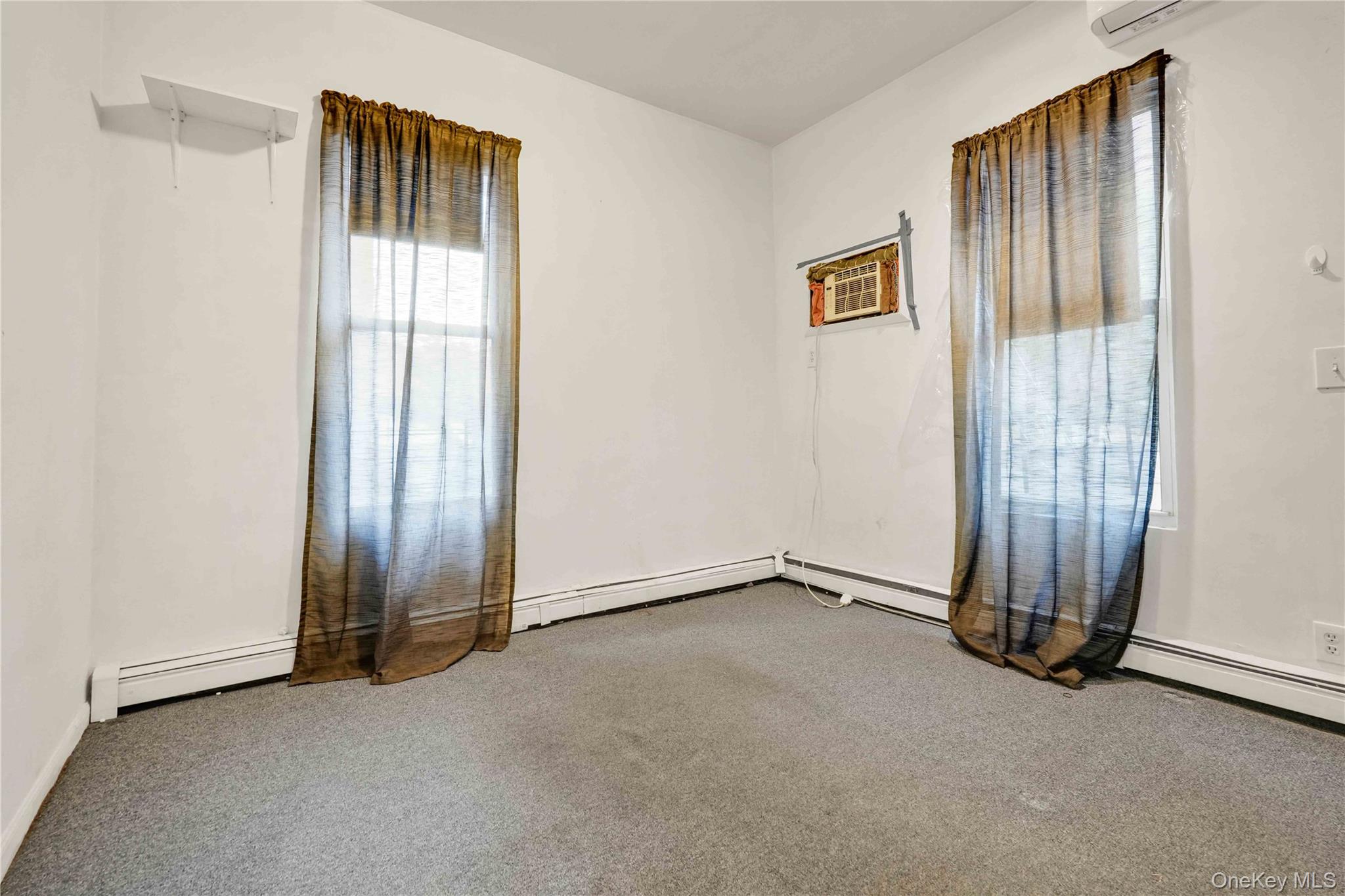 84-39 Lefferts Boulevard, Unit 1 Queens, NY 11415 - Photo 23 of 42 an empty room with windows