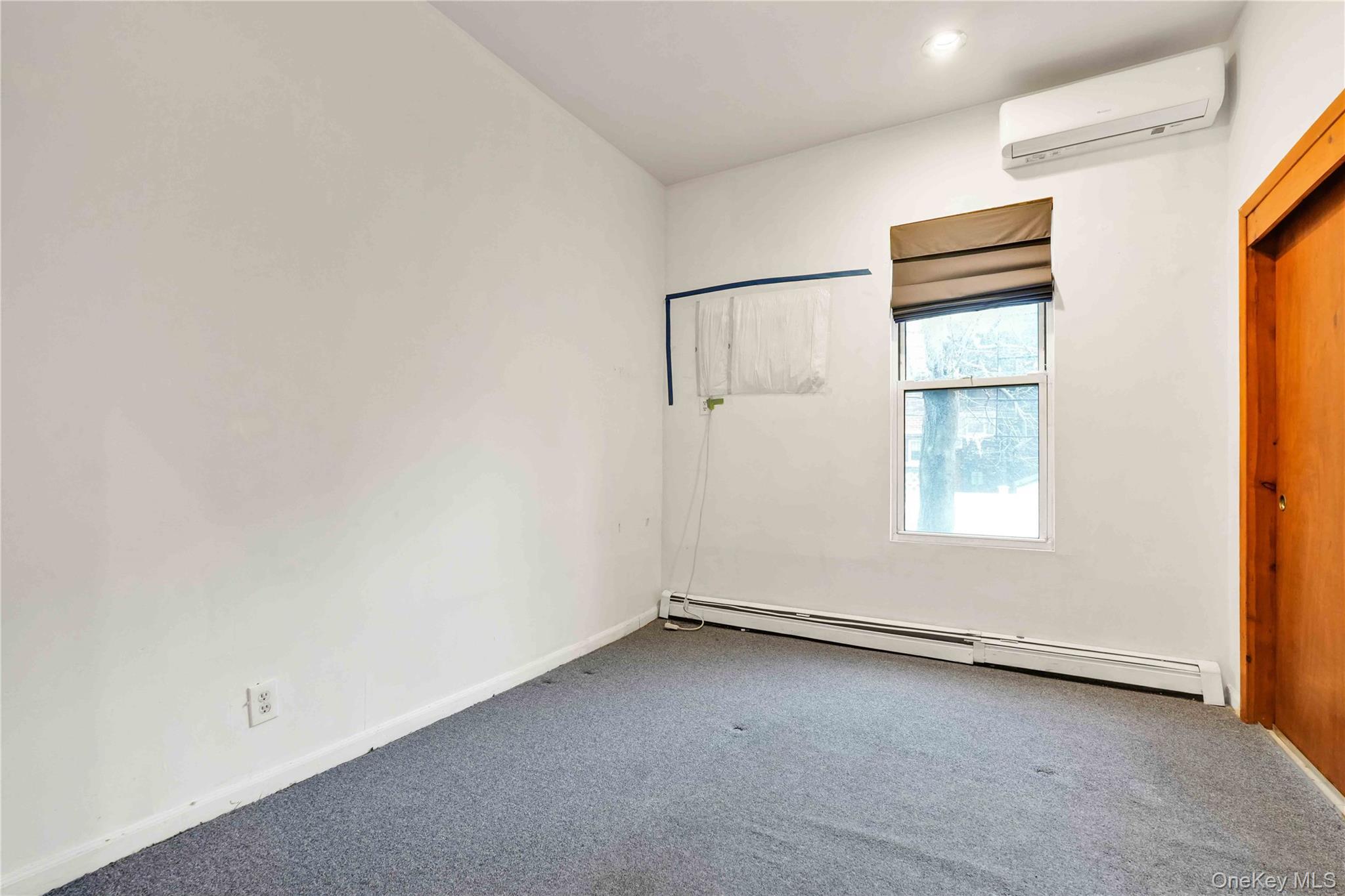 84-39 Lefferts Boulevard, Unit 1 Queens, NY 11415 - Photo 27 of 42 an empty room with a window