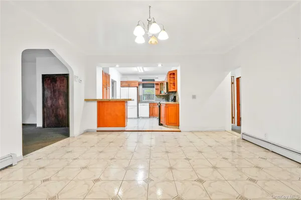 a view of a dining room with furniture and chandelier