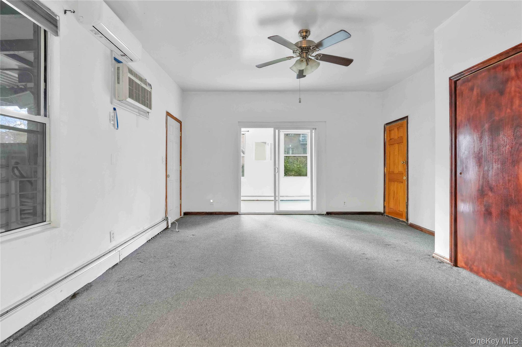 84-39 Lefferts Boulevard, Unit 1 Queens, NY 11415 - Photo 4 of 42 an empty room with a ceiling fan and a window
