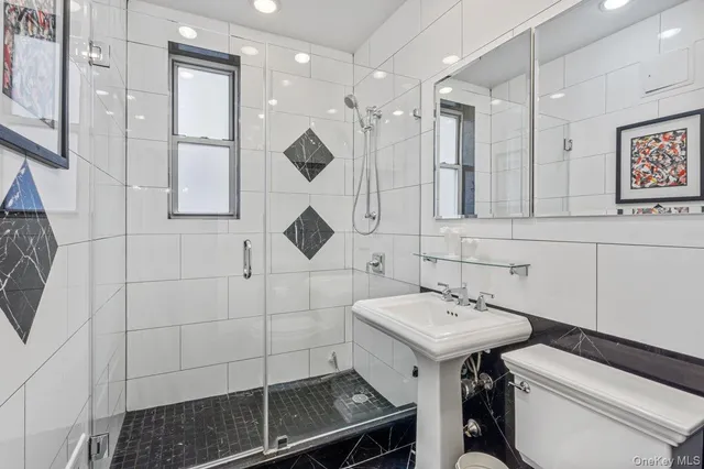 a bathroom with a sink toilet and mirror