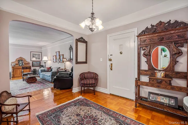 a living room with furniture and a chandelier