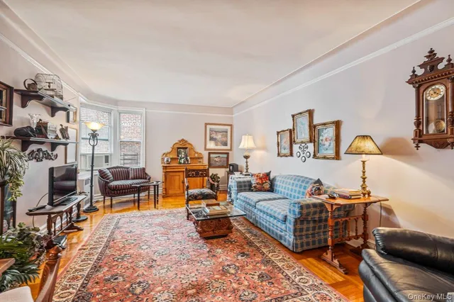 a living room with furniture a lamp and a flat screen tv