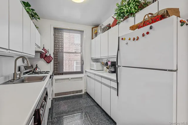 a white refrigerator freezer sitting inside of a kitchen