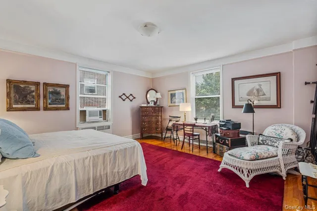 a bedroom with furniture and a wooden floor