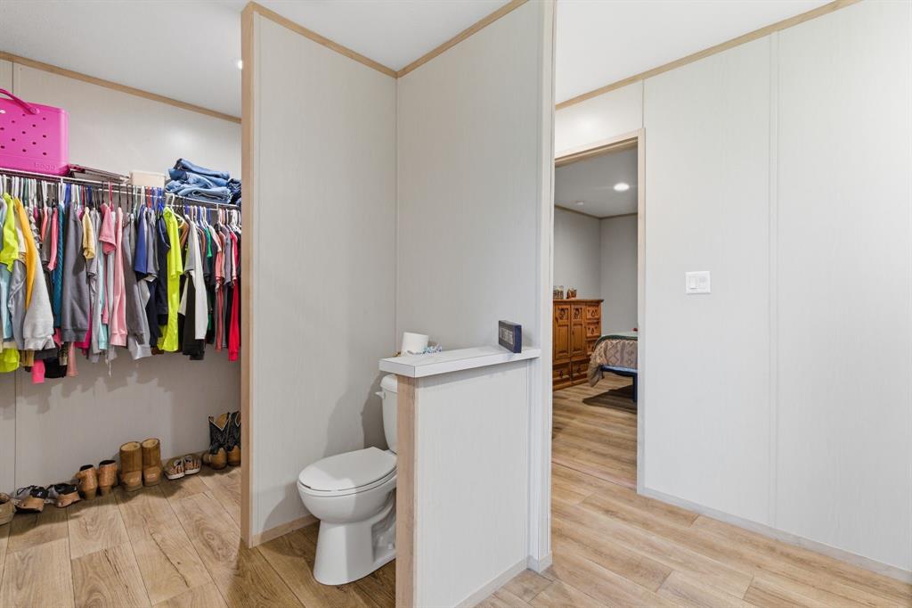 8792 Highway 67 Saltillo, TX 75478 - Photo 22 of 40 a bathroom with a toilet sink and mirror